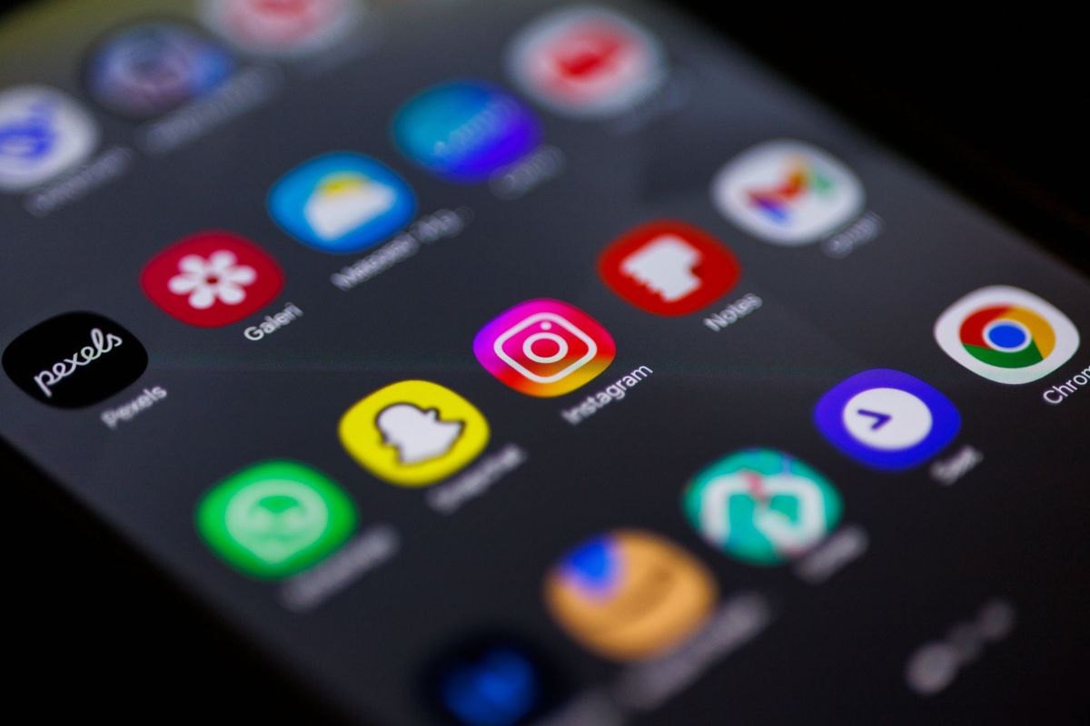 Close-up of a smartphone home screen crowded with colourful app icons